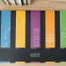 Design and architecture workbook with colorful blueprints on a wooden desk.